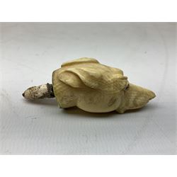 19th century carved ivory walking cane handle, modelled as the head of a greyhound with inset glass eyes, together with a further 19th century ivory example, modelled as a caricature of a gentleman's head, (2)