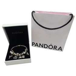 Silver Pandora bracelet with 14ct gold plated heart clasp, with twelve Pandora charms, including Santa's sleigh, Christmas elves, reindeer, fairy, snowflake and polar bear, some with 14ct gold plated accents, with Pandora box and bag