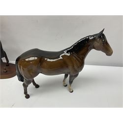 Four Beswick horse figures, comprising Quarter Horse, two Shires no 818 and matt palomino, together with Beswick donkey and Royal Doulton horse on a wooden plinth  