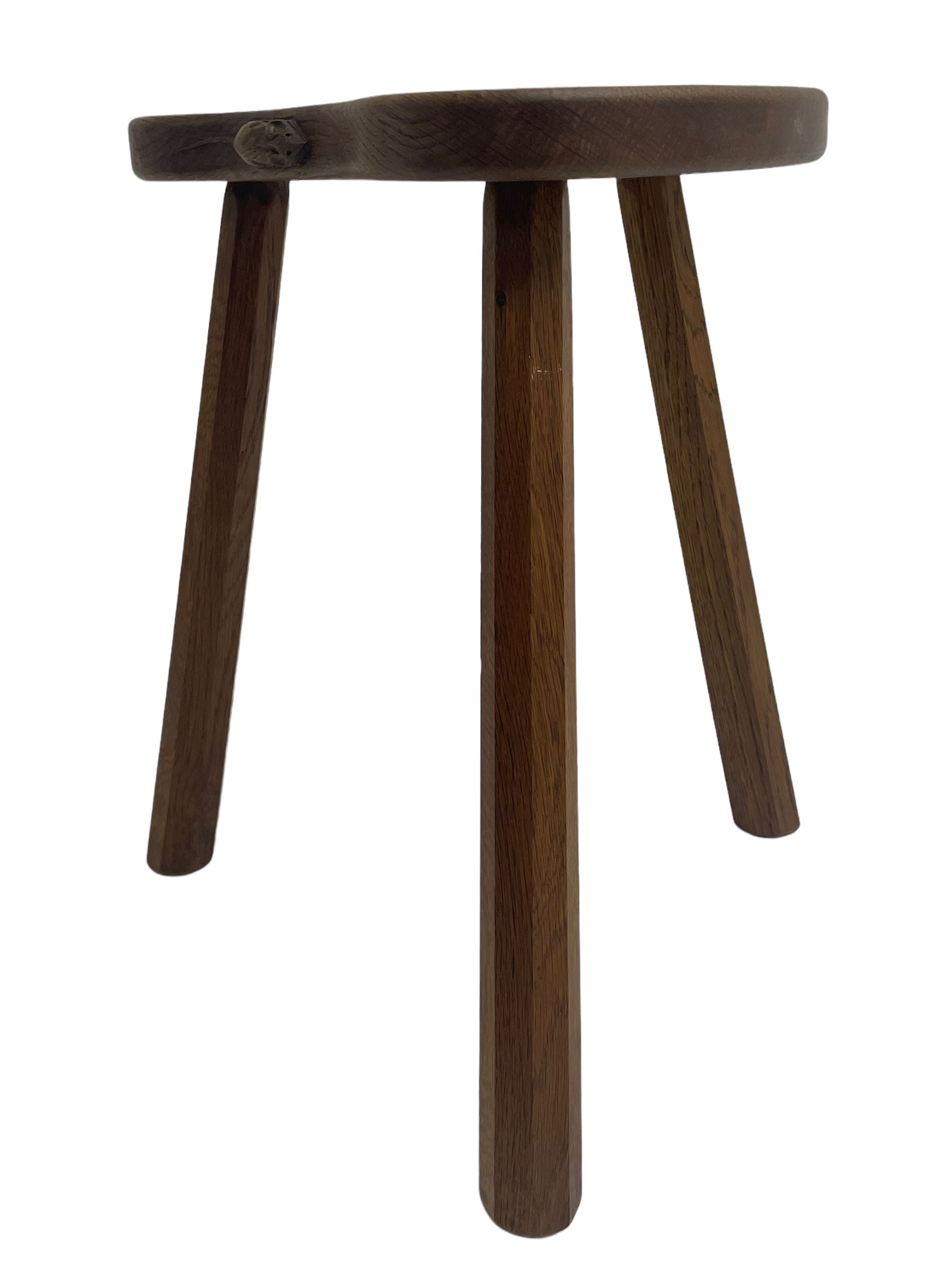 'Mouseman' oak three-legged stool, kidney shaped dished seat carved with mouse signature to edge, by Robert Thomas of Kilburn