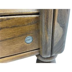 Ercol medium elm framed three seat bergere sofa, and pair of matching armchairs upholstered in red fabric