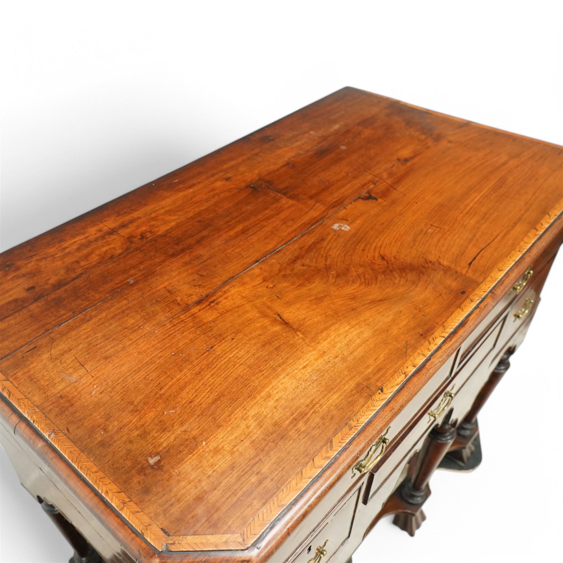 William and Mary design 18th century walnut and yew wood dresser or console table, rectangular canted top with feather banding and moulded edge, over two long and three short cock-beaded drawers, flanked by chamfered uprights above a shaped and cock-beaded apron, raised on six turned and tapering supports united by a shaped box stretcher, on lobed feet 