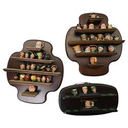 Collection of  forty two miniature Royal Doulton character jugs on three wall shelves, one...