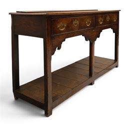 George III oak dresser base, rectangular top with moulded edge, fitted with two drawers over shaped spandrels, raised on square chamfered supports united by undertier, on stile feet