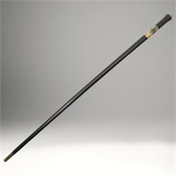 Early 20th century Indian concealed sword-stick, the black wooden scabbard and grip with carved bone collar, engraved brass band, and brass pommel in the form of a tigers head, W92cm