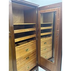 Wylie & Lochhead, Glasgow - early 20th century mahogany and satinwood double wardrobe, projecting cornice over panelled doors, interior fitted with mirrored door, shelves, drawers, hooks and hanging rail, raised on bracket supports with ceramic castors