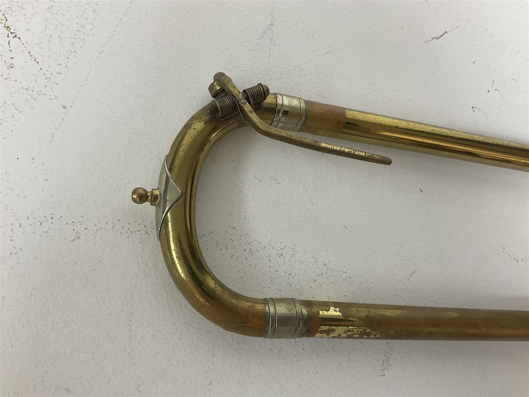 Three brass trombones comprising Elkhart Ind. USA 'CONN' model no.72H; Besson 'Concord'; and Selmer Distributed 'Lincoln'; two in carrying cases; and German B & M 'Champion' brass trumpet (4)