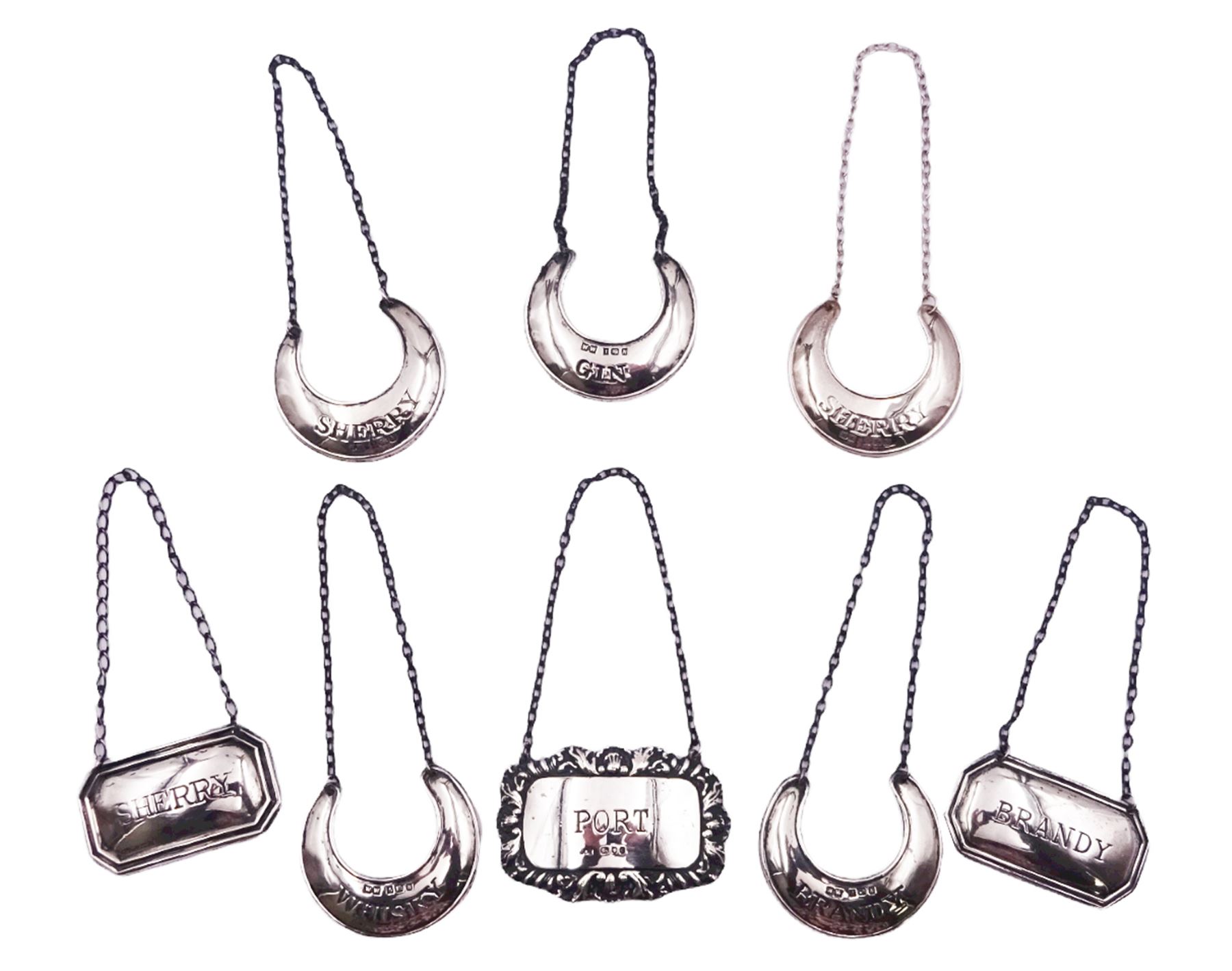Set of five modern silver crescent shaped wine labels, stamped 'Gin', 'Whisky', 'Brandy', and two stamped 'Sherry', hallmarked Birmingham 1987, makers mark W W, two further modern examples of rectangular form with canted corners, stamped 'Sherry' and 'Brandy', hallmarked W I Broadway & Co, Birmingham 1983, and Francis Howard Ltd, Sheffield 1984, and a single example with shell, acanthus and gadrooned edge, stamped 'Port', hallmarked London 1978, makers mark JDS, approximate total weight 2.34 ozt (72.9 grams)
