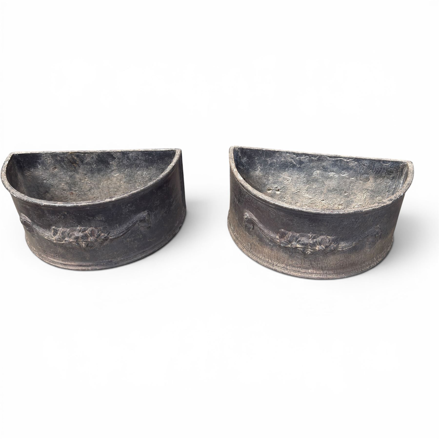 Pair of 19th century decorative lead planters of demi-lune form, decorated with raised relief floral swag decoration