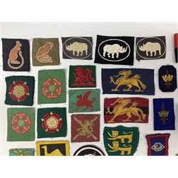 Approximately one-hundred printed and embroidered cloth badges including Royal Tank Regiment, Royal Armoured Corps, 219th Independent Infantry Brigade, Cyrenaica, Cyprus, Singapore and other districts, Gibraltar Garrison, East Anglian Brigade, 20th Armoured Brigade and various armoured divisions etc