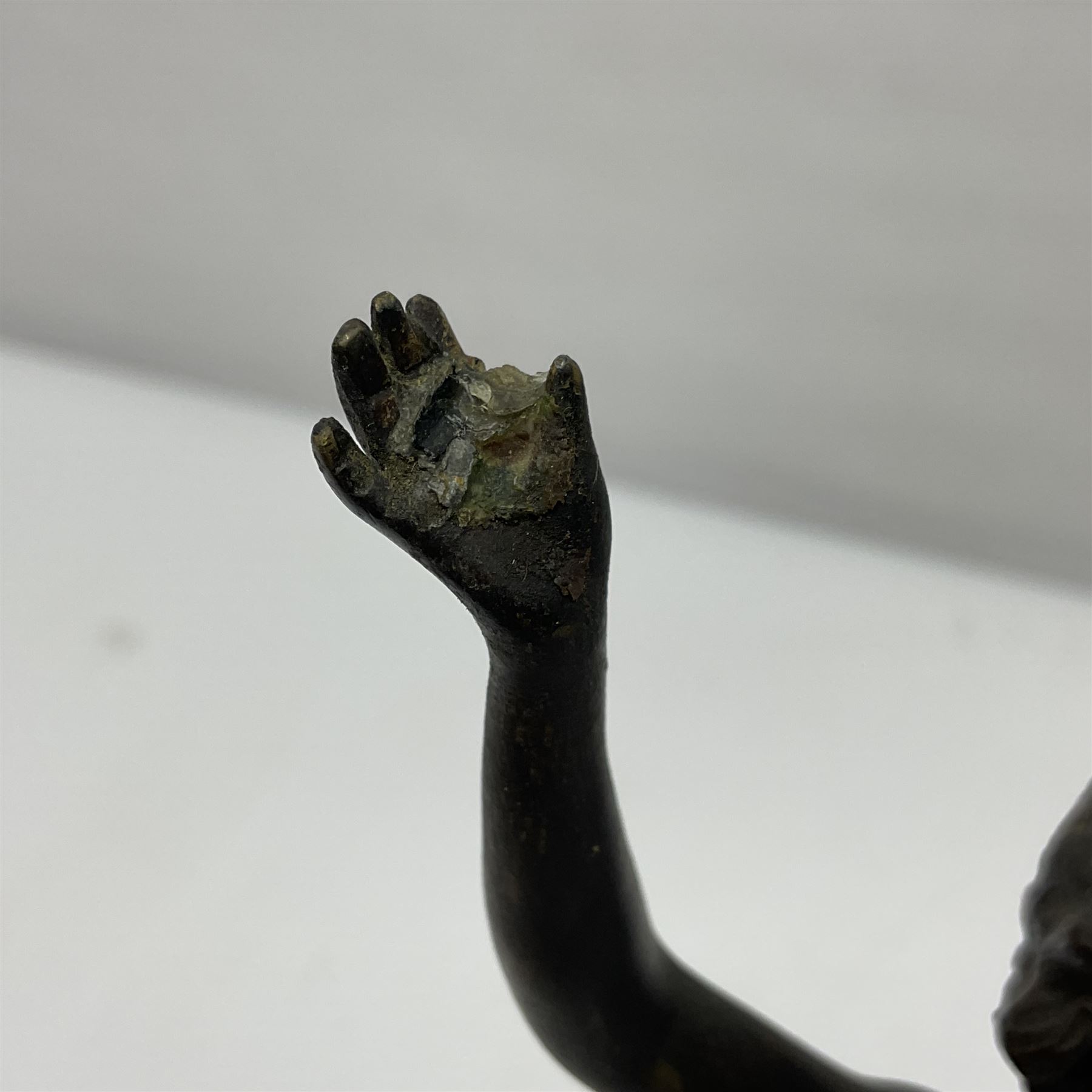 Bronze figure modelled as a nude woman with one arm raised a crescent moon upon her forehead, raised upon a circular stepped plinth, H36cm