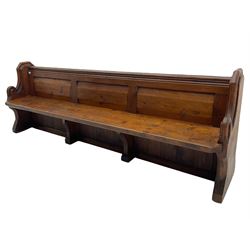 Victorian pine church pew, moulded cresting rail over triple panelled back, shaped end supports joined by plank seat