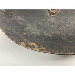Indian black lacquered hide shield/dhal, of circular convex form fitted at its centre with four pierced iron bosses, each of hemispherical form with wide brims, the bosses corresponding on the inside with four iron rings for enarmes D53.5cm