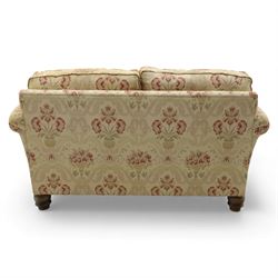 Late 20th century two seat sofa upholstered in floral beige and red fabric, turned supports 