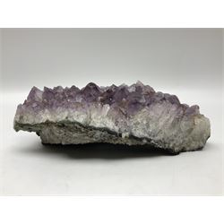 Amethyst crystal geode cluster, with well-defined crystals of various sizes, H10cm, L30cm