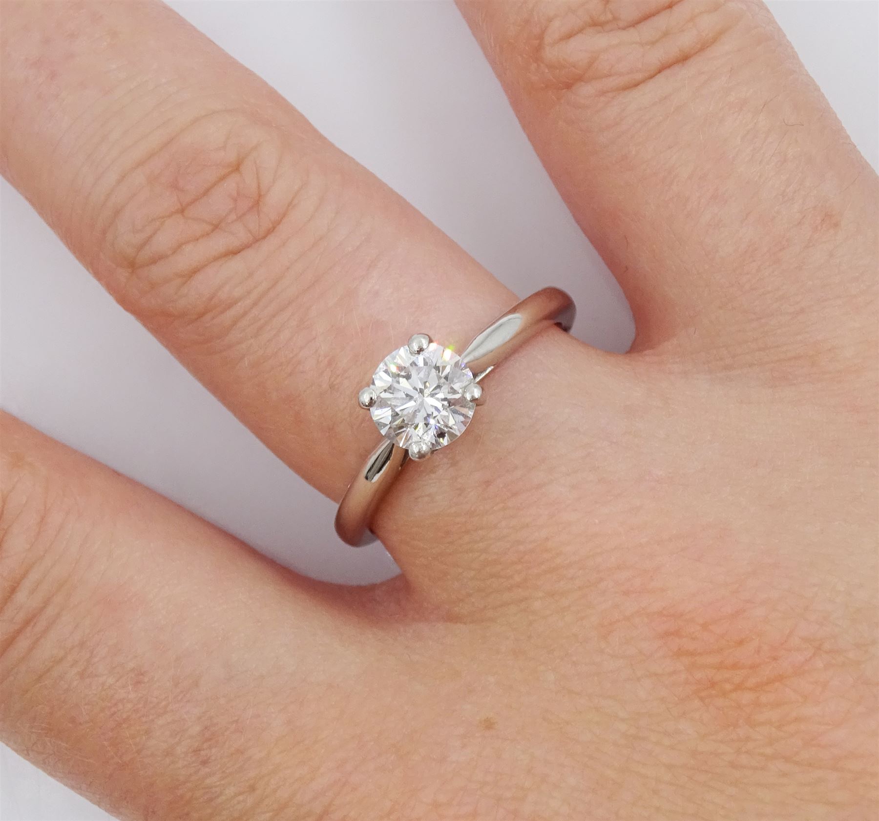 Platinum diamond ring, single stone round brilliant cut diamond of 0.91 carat, in a four claw setting, hallmarked, with GIA report, colour F, clarity SI2
