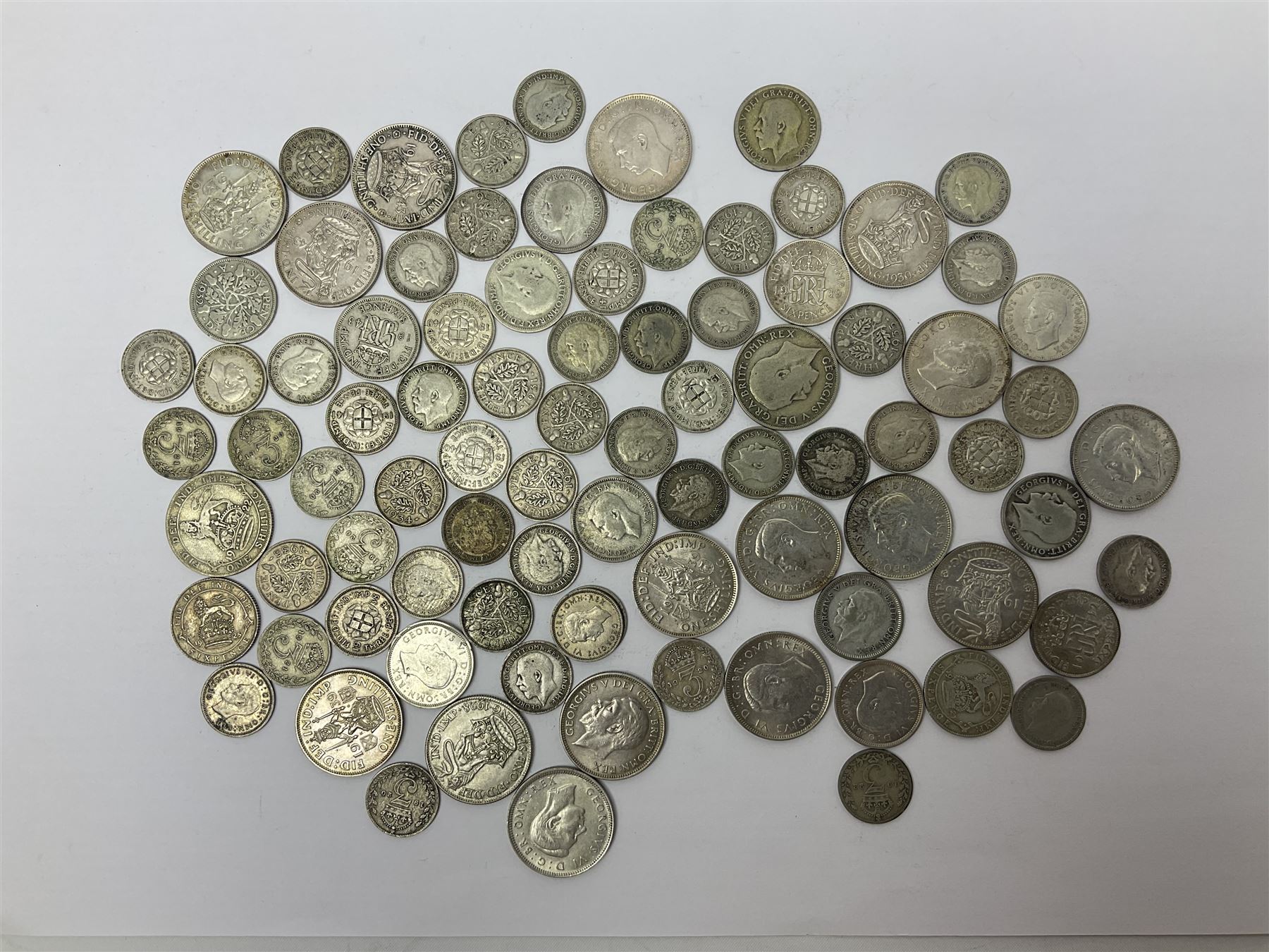 Approximately 260 grams of Great British pre 1947 silver coins, including one shillings, sixpences and threepence pieces 