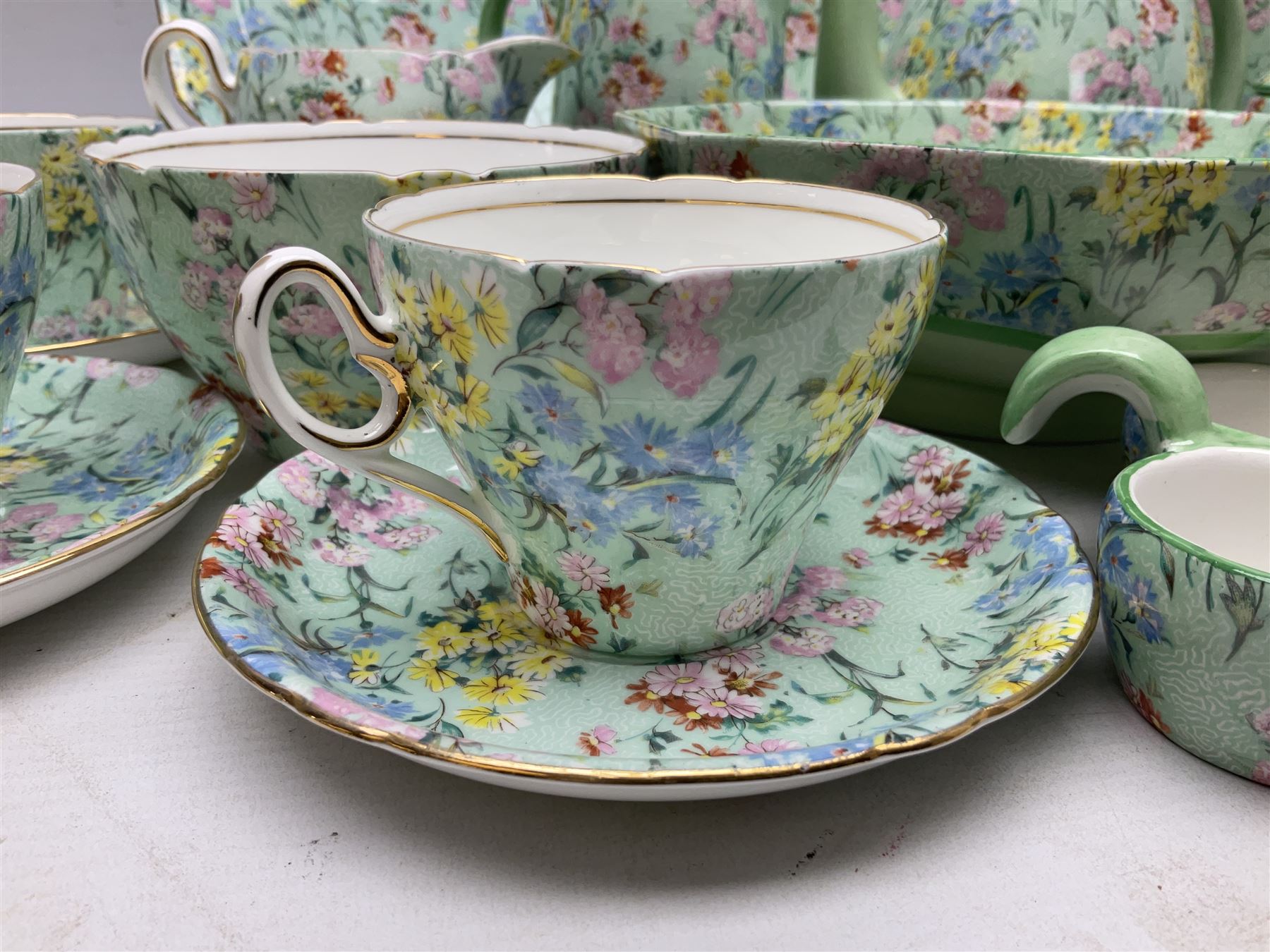Shelley Melody pattern tea service for six, to include teapot, teapot stand, hot water jug, milk jug, covered sucrier, teacups and saucers, cake plates etc (31)