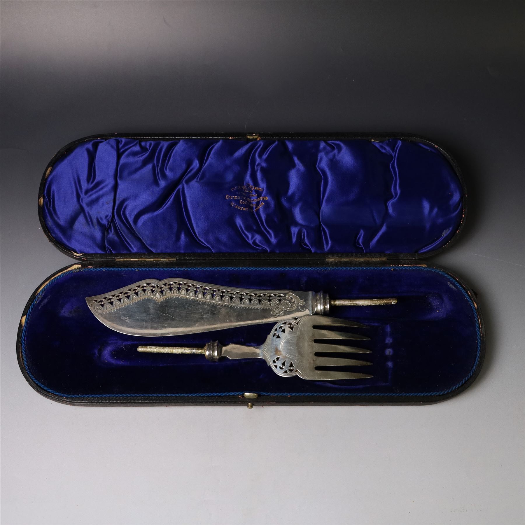 Pair of late Victorian silver fish servers, each with pierced and engraved geometric decoration, hallmarked Goldsmiths & Silversmiths Co, London 1896, handles removed, contained within fitted case