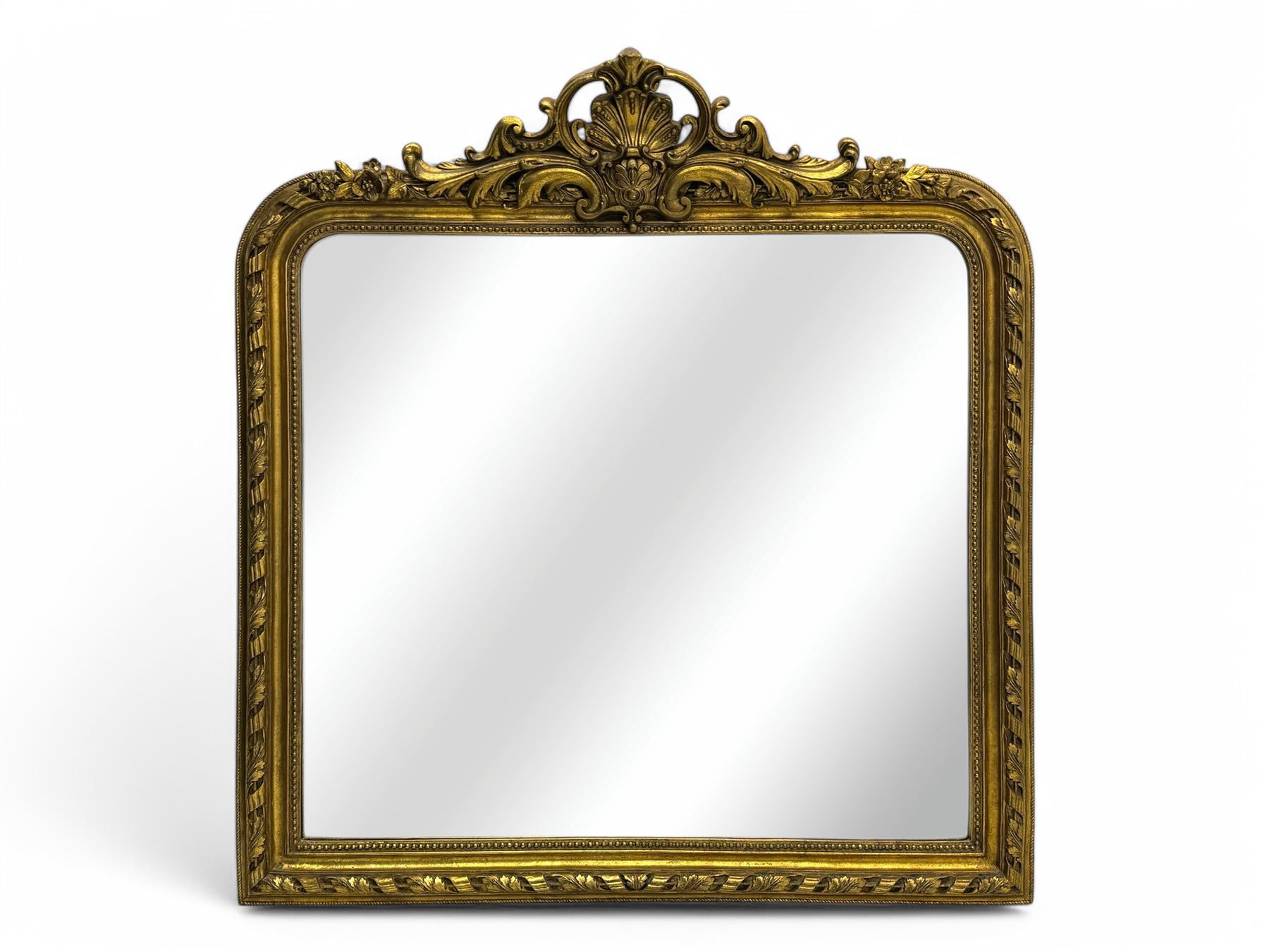 18th century design ornate gilt framed overmantle mirror, bevelled mirror plate within arched frame with pierced pediment featuring foliate and scrollwork designs