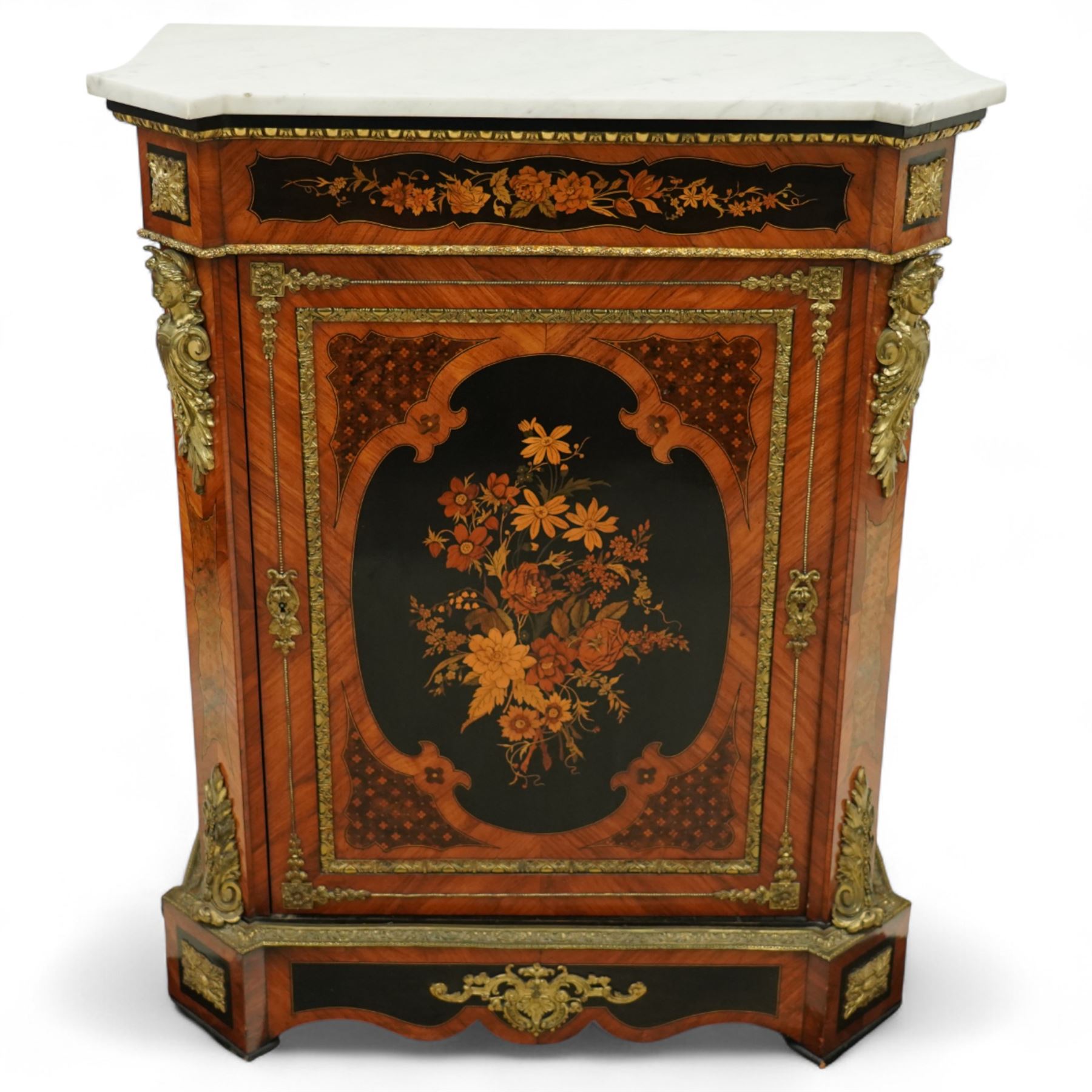 Late Victorian floral marquetry and ormolu mounted side cabinet, with white marble top above a frieze of floral inlay, single cupboard door revealing a shelved interior, with central floral bouquet panel within gilt-bronze border, flanked by gilt metal mounts of female masks and scrolls, on shaped plinth base