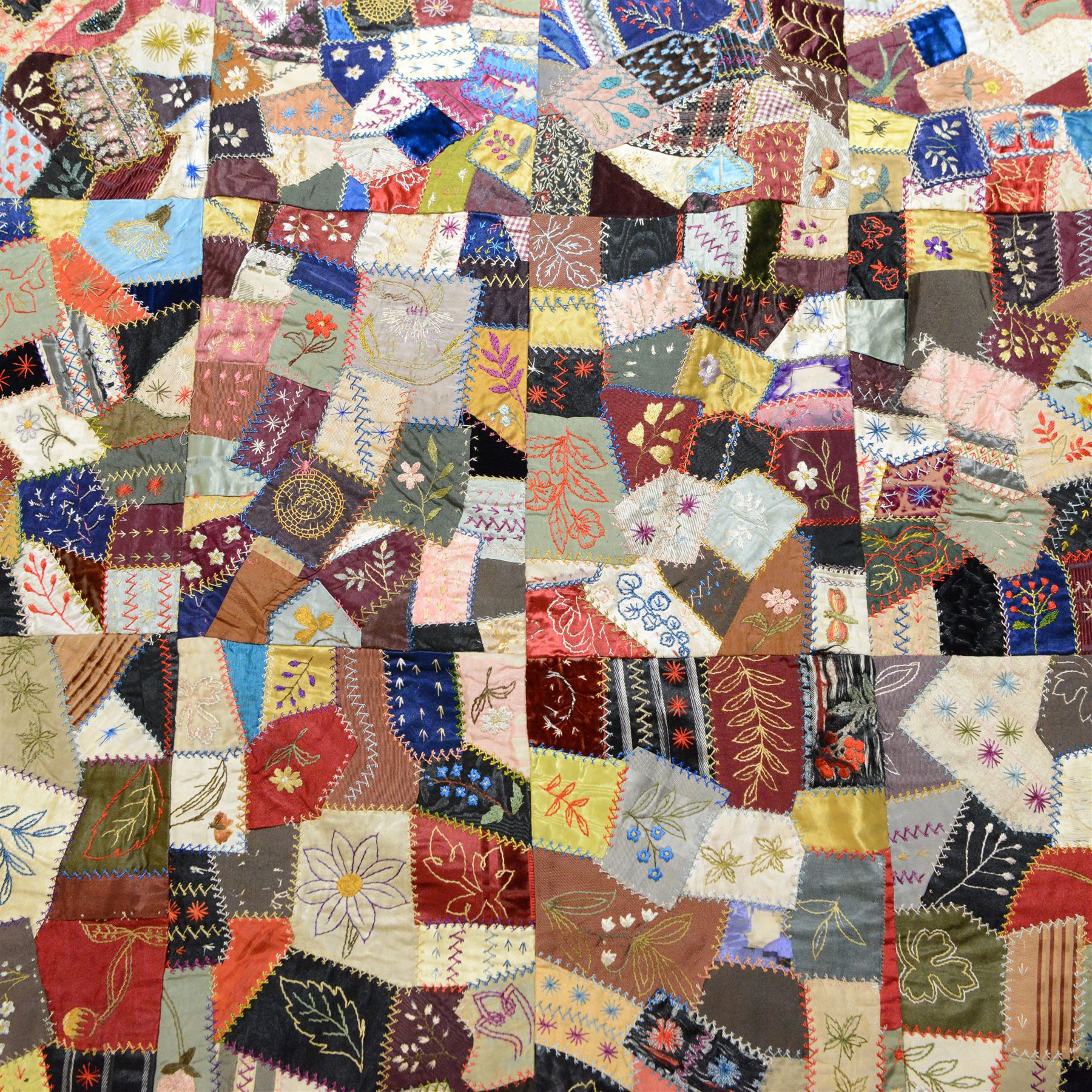 Victorian crazy pattern patchwork quilt, of irregular scraps, within a silk and lace border, L174cm, W134cm
