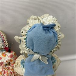 Anna Meszaros Hungary - three hand made needlewrok figurines - each wearing a lon floral dress and bonnet and holding a bouquet of flowers, tallest H32cm (3)  Auctioneer's Note: Anna Meszaros came to England from her native Hungary in 1959 to marry an English businessman she met while demonstrating her art at the 1958 Brussels Exhibition. Shortly before she left for England she was awarded the title of Folk Artist Master by the Hungarian Government. Anna was a gifted painter of mainly portraits and sculptress before starting to make her figurines which are completely hand made and unique, each with a character and expression of its own. The hands, feet and face are sculptured by layering the material and pulling the features into place with needle and thread. She died in Hull in 1998.