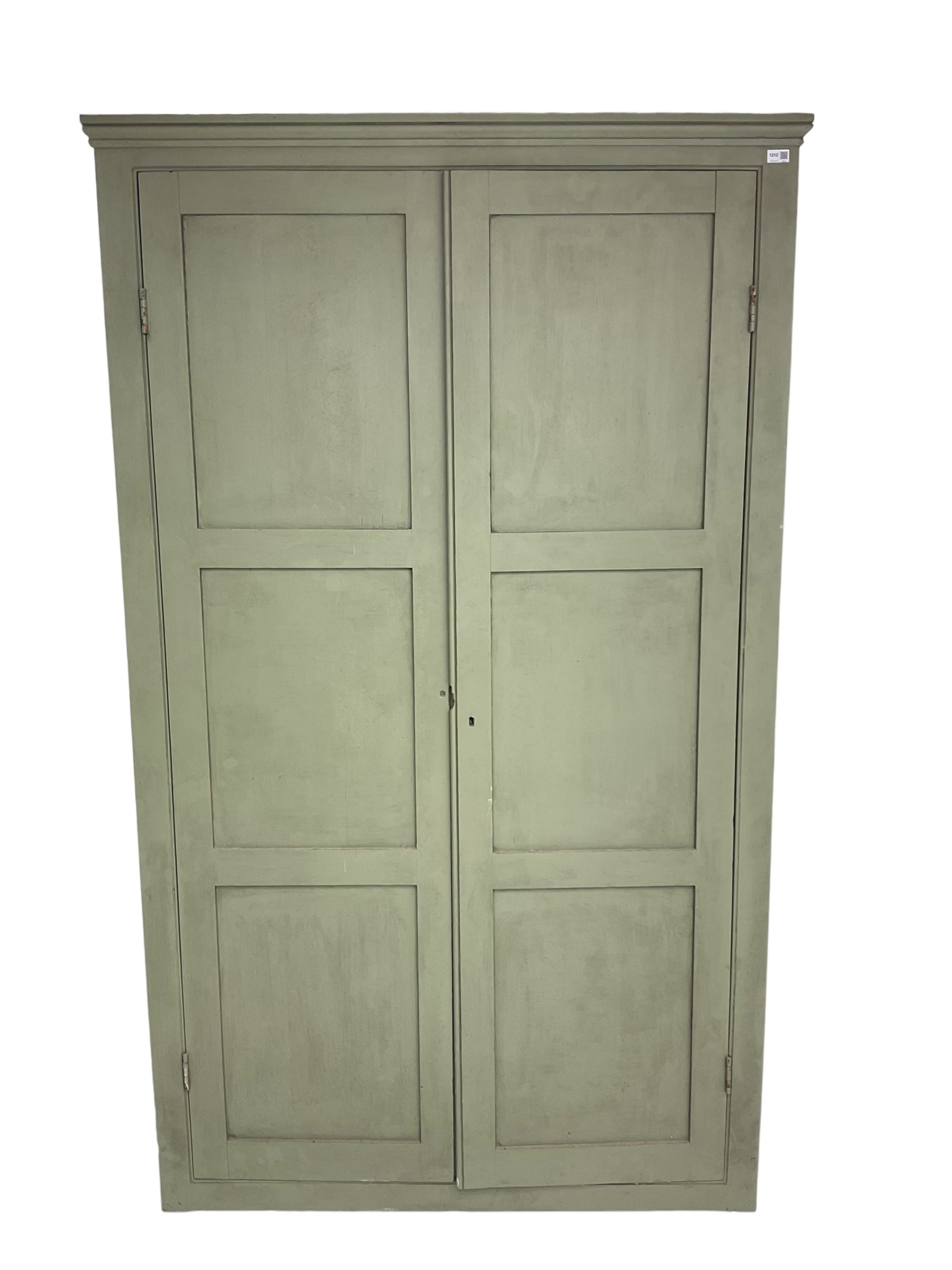 Painted pine cupboard, two panelled doors enclosing four shelves, in laurel green finish