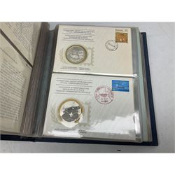 Thirty-six 'International Society of Postmasters Official Commemorative Issues' sterling silver proof medallic covers dating from 1975 to1977, housed in the official folder