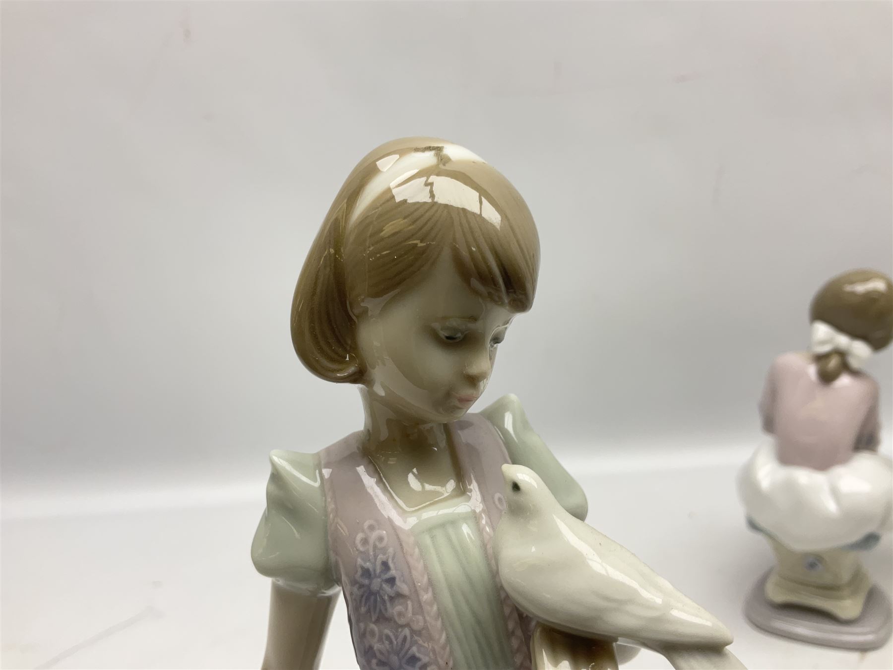 Three Lladro figures, comprising Garden Classic, signed no 7617, Summer Stroll no 7611 and Best Friend no 7620, all with original boxes, largest example H24cm 