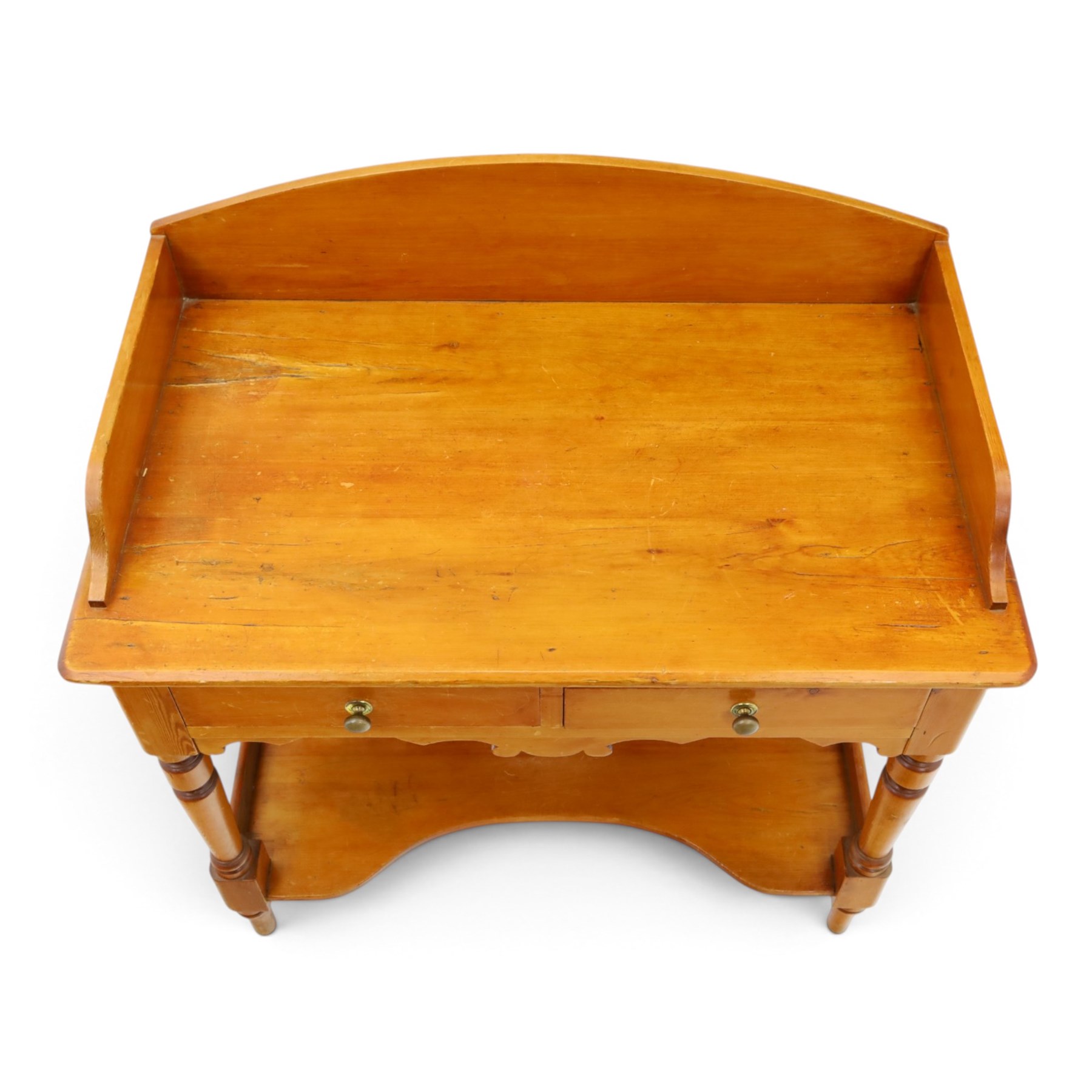 Victorian pine washstand, raised three quarter galleried top, fitted with two drawers, raised on turned supports united by a shaped full length under tier 