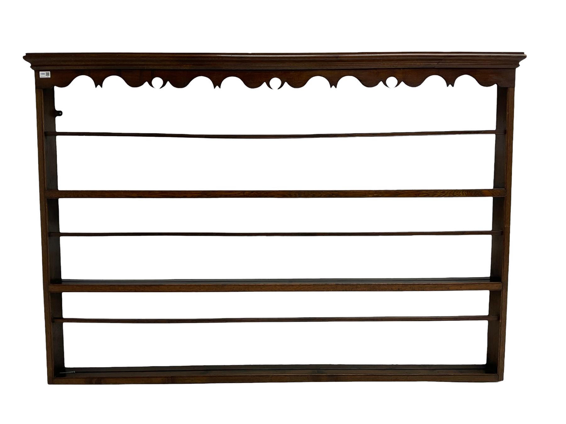 20th century oak wall hanging plate rack, shaped fretwork frieze over three tiers