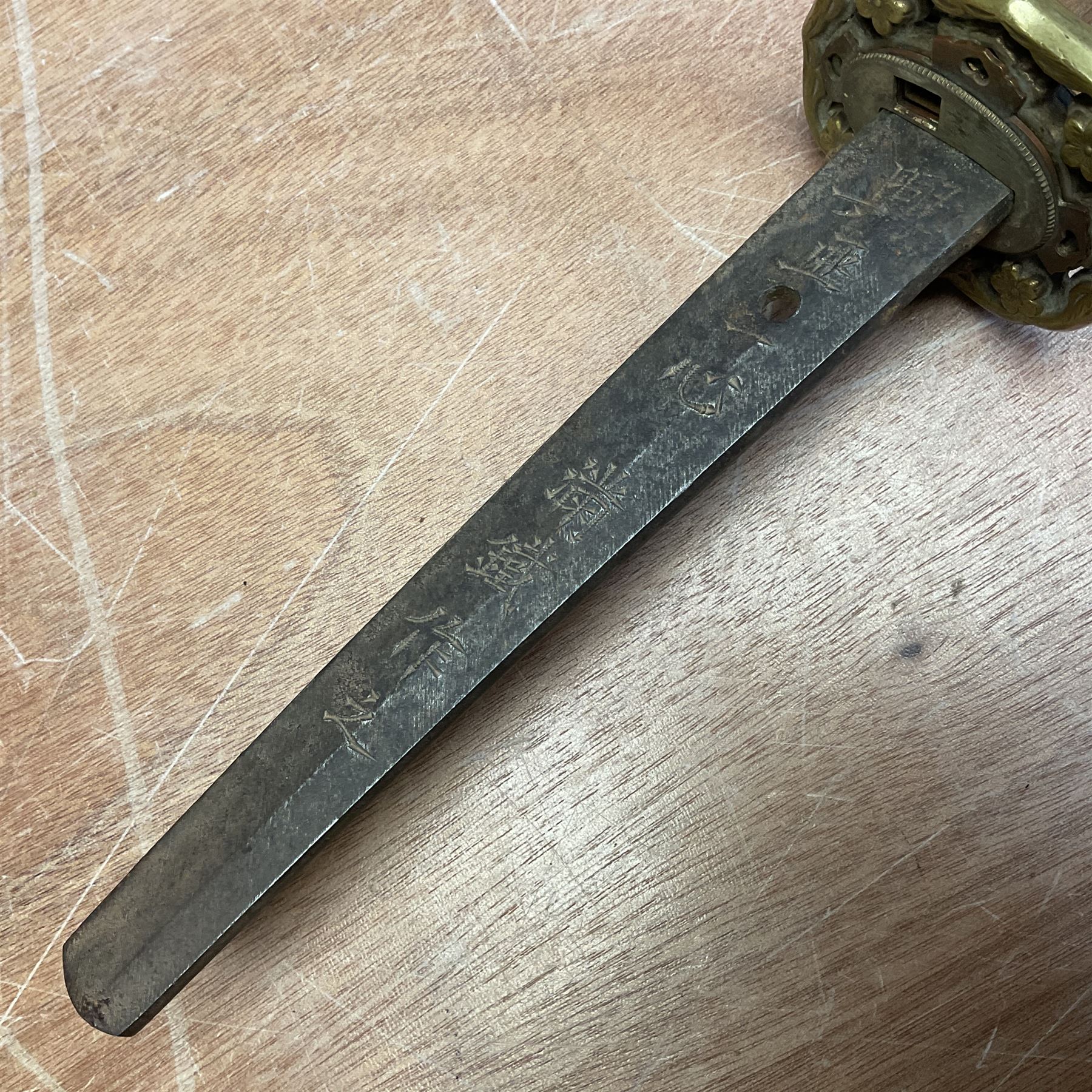 WW2 Japanese Army officer's shin gunto/katana sword with 68.5cm steel single edged blade, foliate cast brass tsuba, bound fish-skin grip with brass mounts, inscribed marks to both sides of tang; in lacquered wooden scabbard with brass mounts and locking button L97cm overall