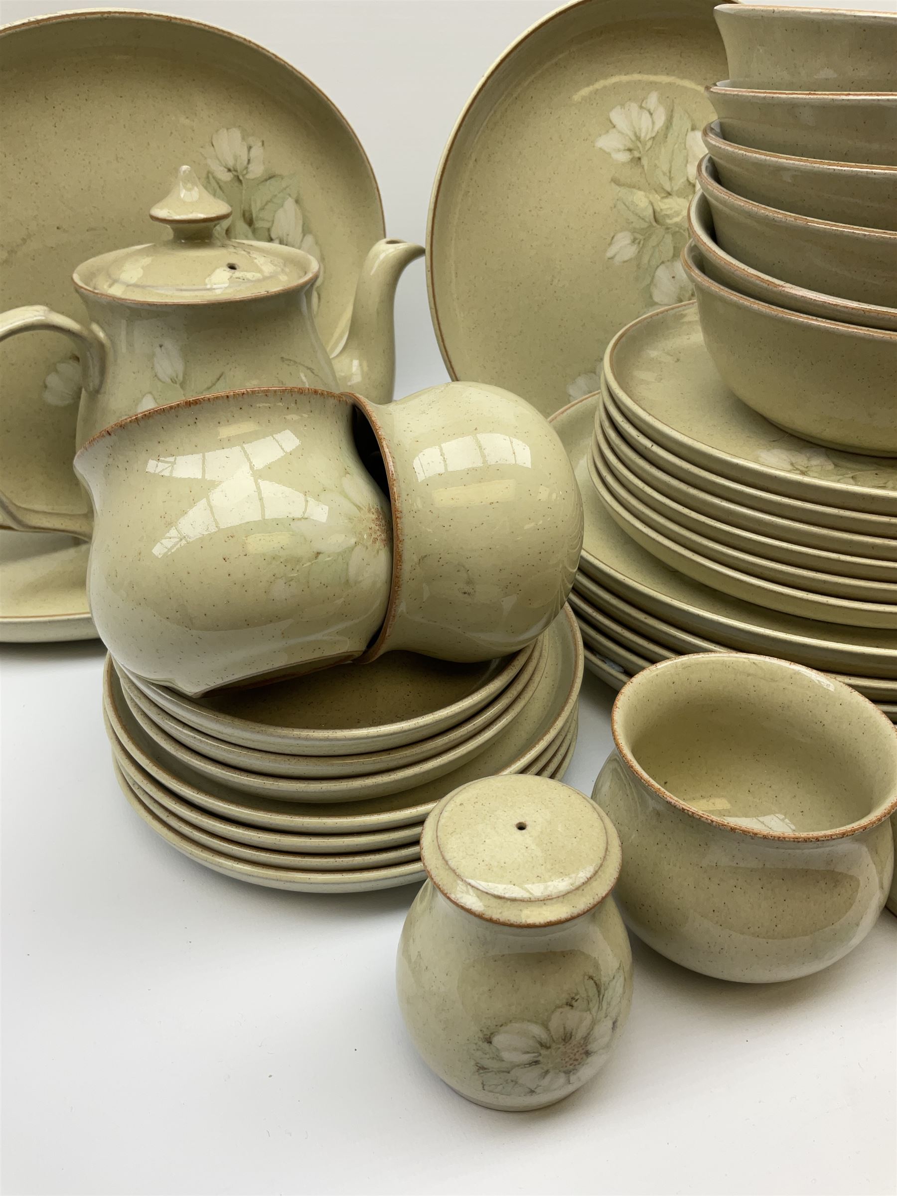 Denby tea and dinner ware decorated in the Daybreak pattern, comprising of tea pot, two jugs, seven cups and six saucers, salt and pepper shakers, four oval platters, six side plates, starter plates, dinner plates and bowls.