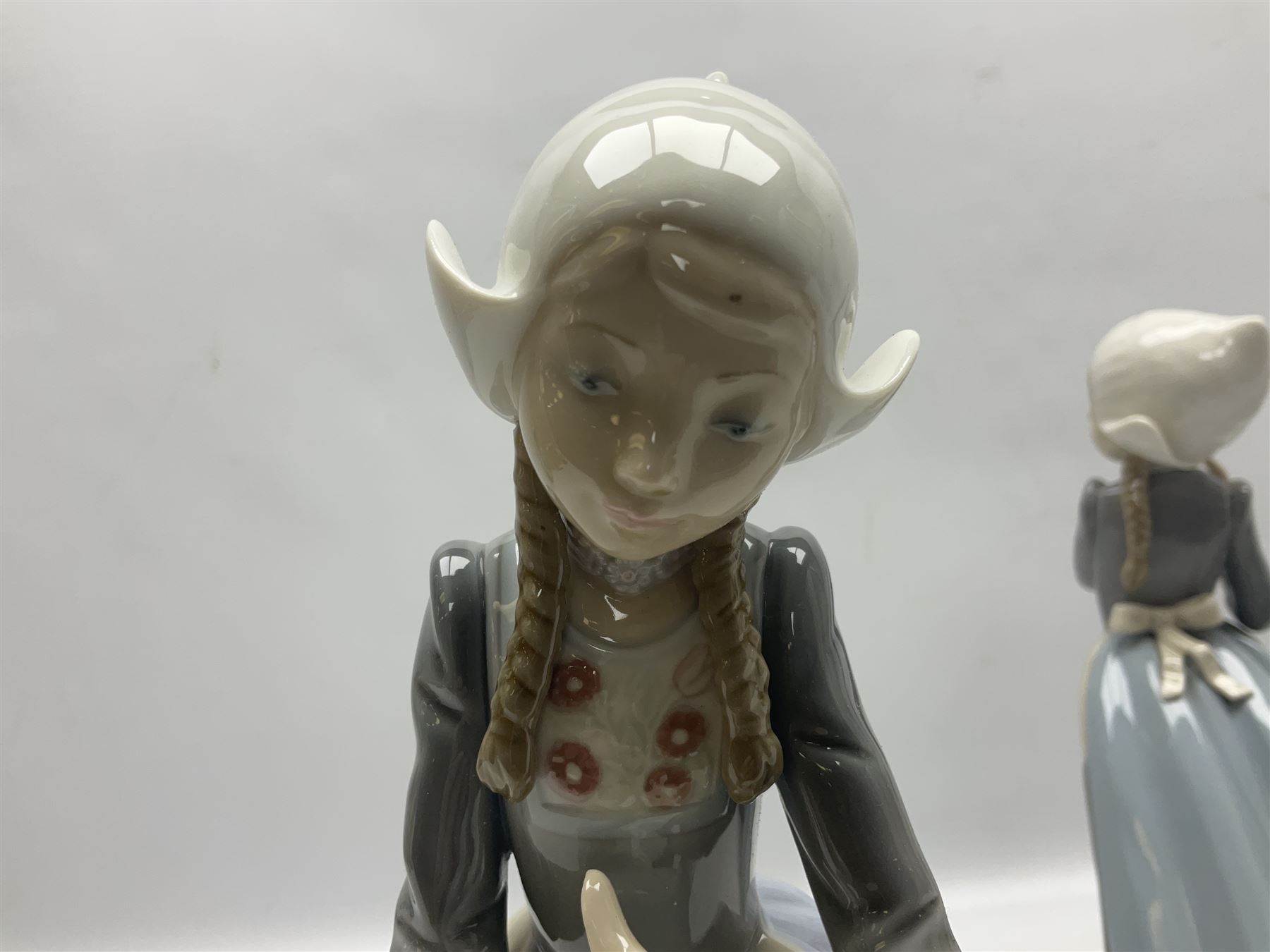 Three Lladro figures, comprising Dutch Girl with Braids no 5063, Dutch Girl with Duck no 5066 and Aracely with Ducks, all with original boxes, largest example H25cm