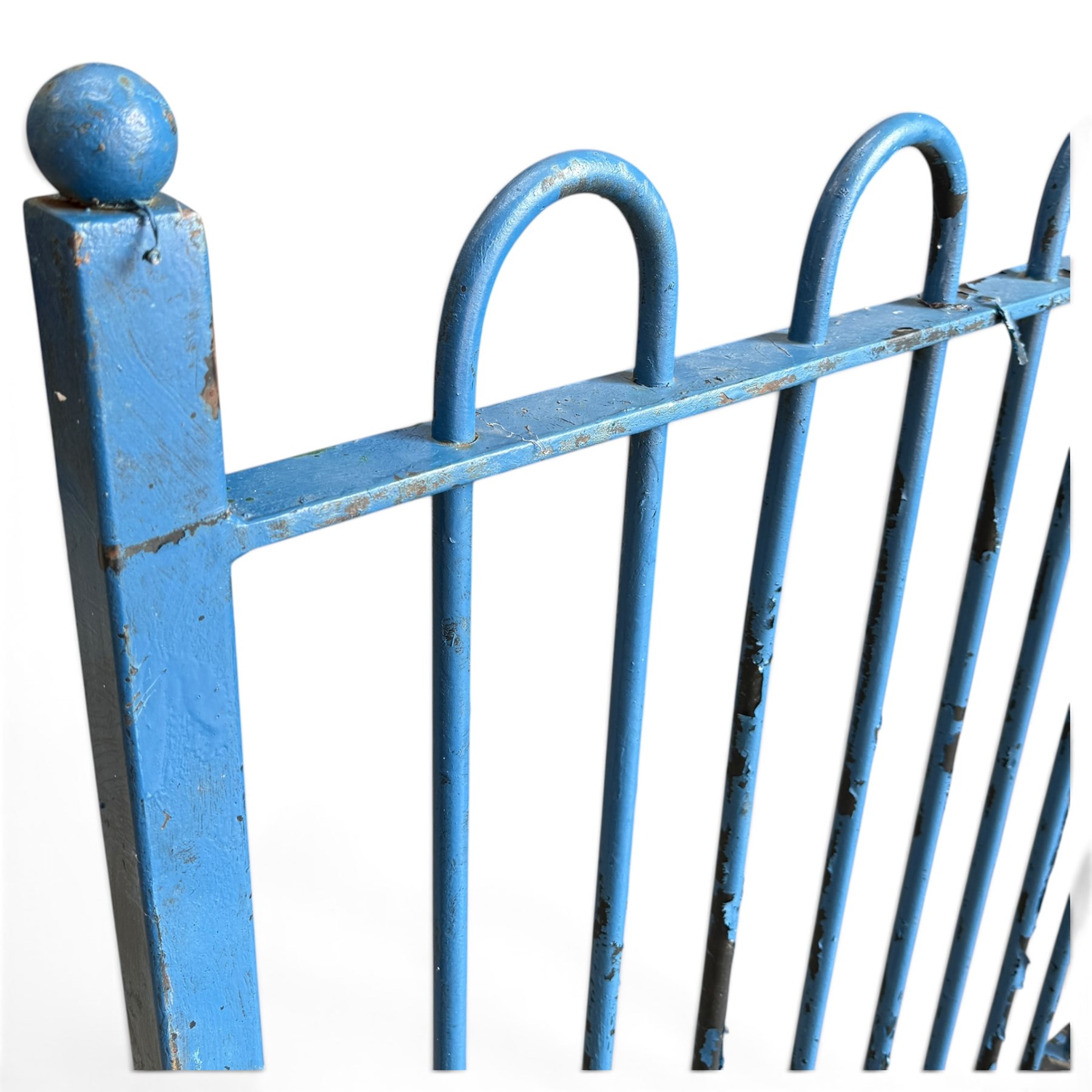 Two sections of painted iron garden or estate boundary railing, comprising a 19th century wrought iron section with graduated spearhead uprights, together with a later hoop-top section with ball-finial end posts, both in blue painted finish