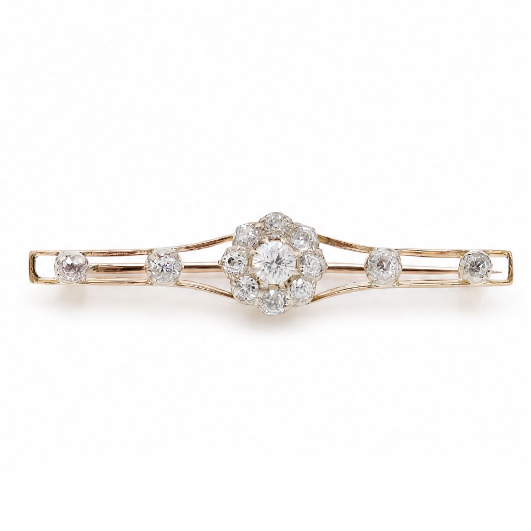 Early 20th century gold and silver diamond brooch, the flower head cluster set with nine old cut diamonds, to split design shoulders, either side set with two further diamonds, total diamond weight approx 1.25 carat