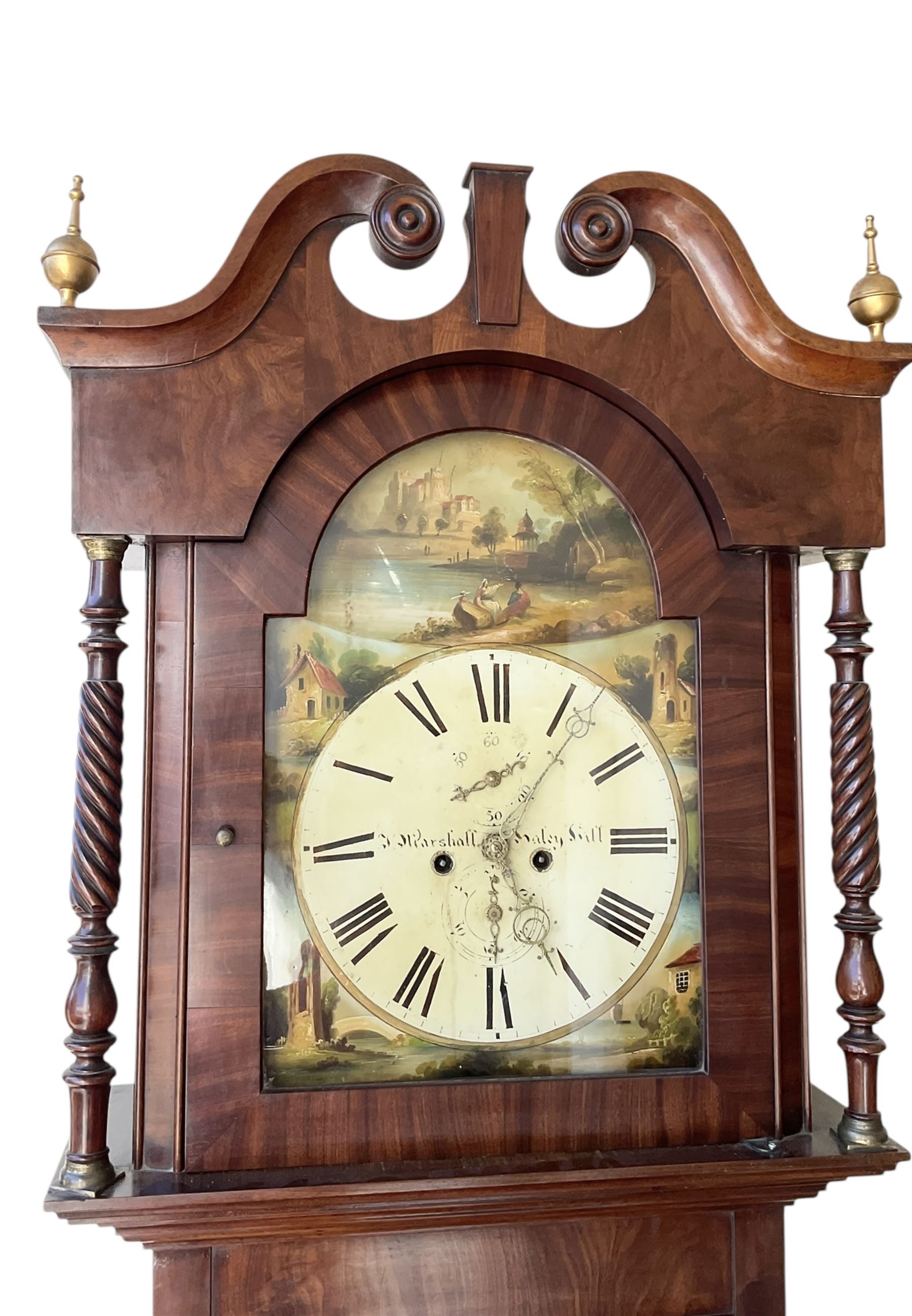 S Marshall of Saley Hill - late Victorian eight day mahogany longcase clock c1860, with a swan necked pediment and brass spire finials, break arch hood door beneath flanked by ring turned pilasters, trunk with inset twin columns and a short three spire door, on a broad plinth with a shaped base, fully painted dial with depictions of cottages to the spandrels and a rural scene to the arch, with Roman numerals , brass hands, seconds and calendar dials, dial pinned directly to a rack striking movement, sounding the hours on a bell. With weights and pendulum.