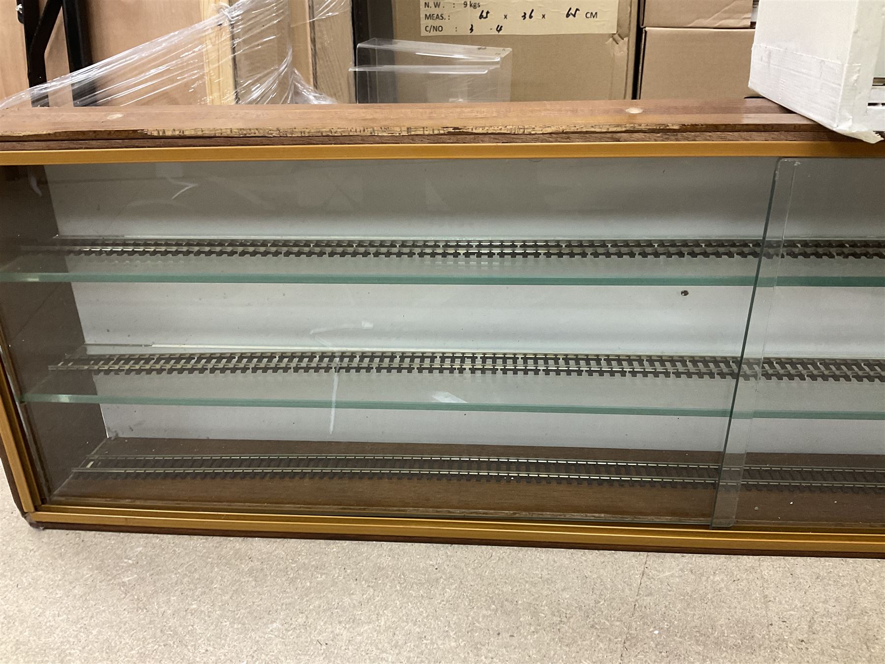 Six shelved cabinets for displaying ‘00’ gauge locomotives comprising plain plywood and white painted examples with track applied to various shelves, largest H63cm, W107cm, D27cm; Collection of tools for building model locomotives to include Weller PU-2D Soldering Pencil and Standard Tip Soldering Iron 20W/230V, Humbrol Modellers Airbrush, Power Supply Units and two wooden chests one of which housing a collection of tools including tweezers, scalping tools, wrenches etc 