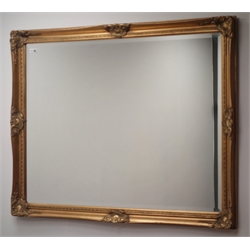  Rectangular wall mirror in swept gilt frame, bevelled glass plate, 88cm x 114cm  