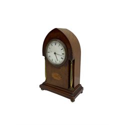 Mahogany “lancet”  shaped Edwardian bedside clock c1900 with contrasting stringing and a fan inlay motif, recessed brass baluster pillars to the case and a shallow moulded plinth raised on ball feet, with an enamel dial, Roman numerals, minute track and steel baton hands, spring driven “drum” movement with a platform escapement. With Key.

