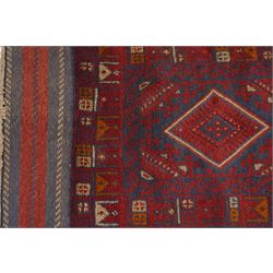 Near pair of Afghan Meshwani runner rugs, each with four red lozenge medallions on a blue ground interspersed with hooked geometric motifs, enclosed by patterned red borders, striped kilim end panels (2)