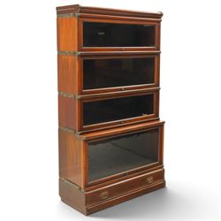 Globe Wernicke - early 20th century mahogany four-tier stacking library bookcase, the shelves fitted with glazed up-and-over doors, fitted with single drawer to the skirted base