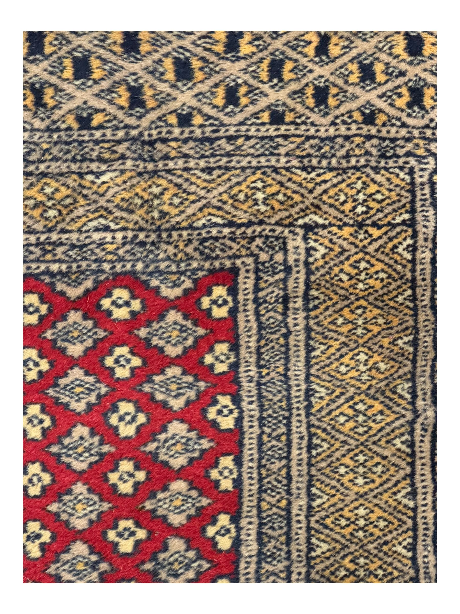 Pakistani Kashan hand-knotted rug with a central medallion and intricate geometric floral patterns, set against a red field and framed by a multi-band border (156 x 94cm); Pakistani Kashan rug with a repeating floral motif across the red field, enclosed by a detailed geometric border in complementary tones (162 x 95cm)