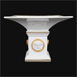 Rosenthal Versace Gorgona pedestal dish, of square form, decorated in relief with Medusa masks and with gilt Greek key borders to the rim and base, boxed, H15cm