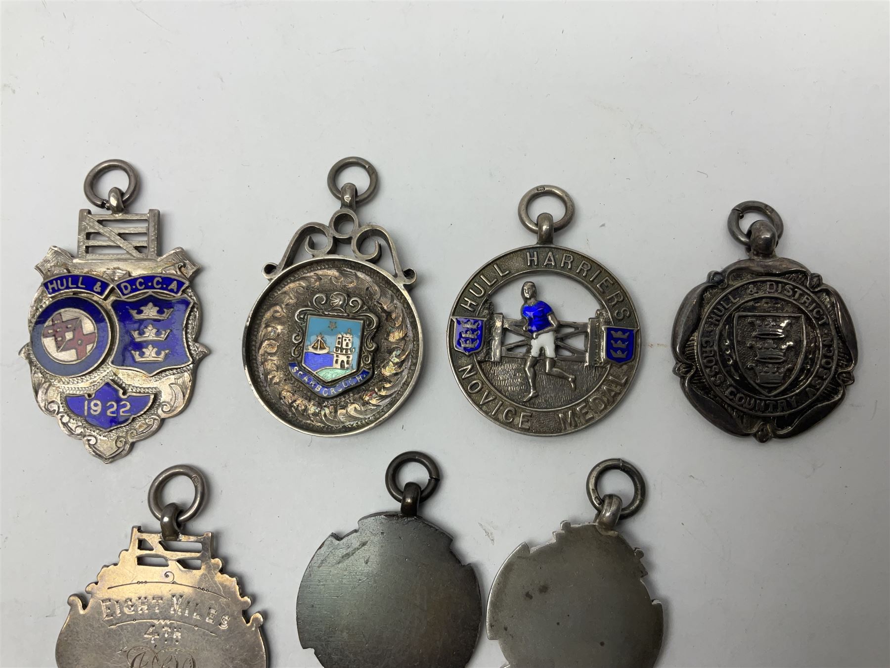 9ct gold enamel 'Hull' charm, together with eight silver fob medallions, six with enamel decoration relating to Hull and one Scarborough example, all hallmarked 