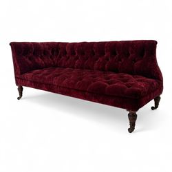 Late Victorian upholstered chaise longue in buttoned red velvet, shaped backrest, on turned walnut legs 