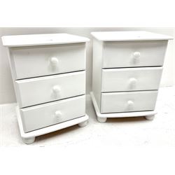 Pair painted pine bedside chests, three drawers, turned supports 