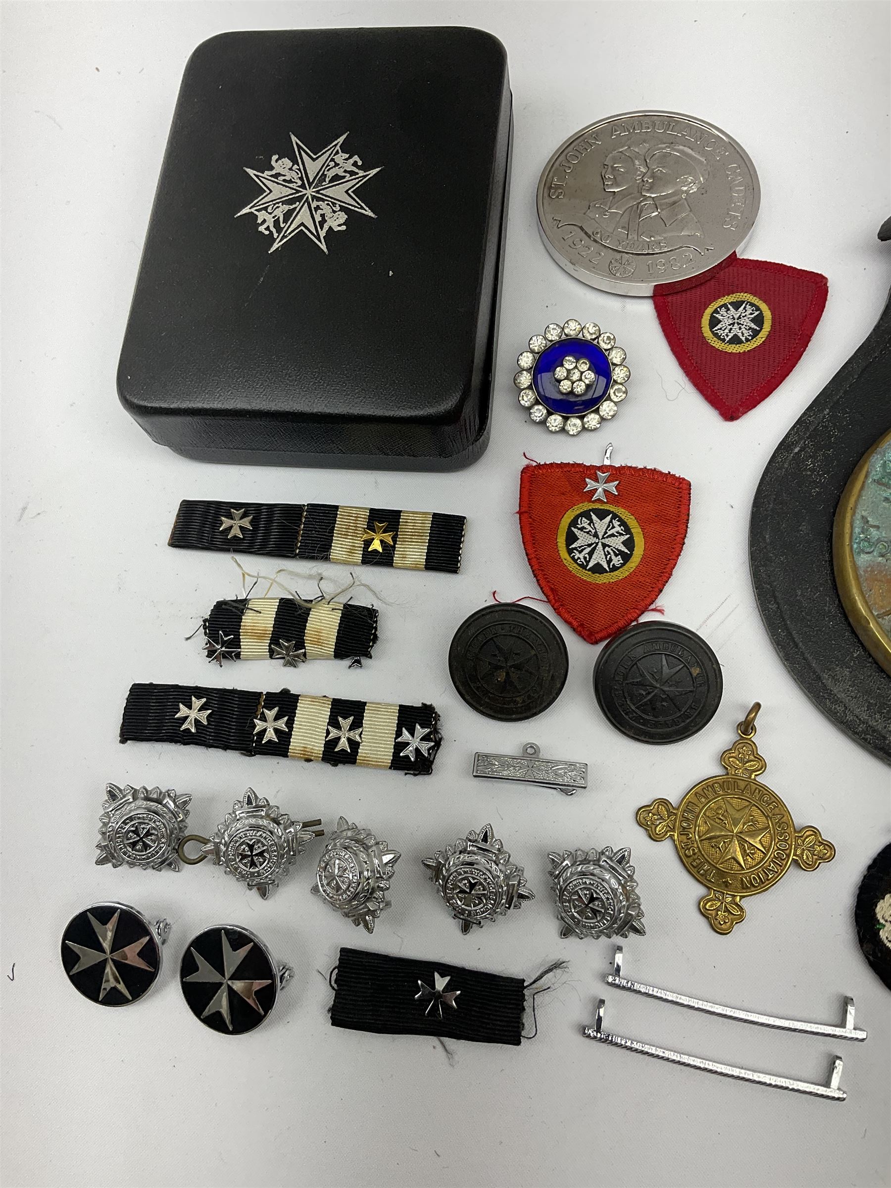 Collection of St John Ambulance enamel, metal and embroidered badges, together with St John Ambulance cadets sixty years medallion and a horse brass  