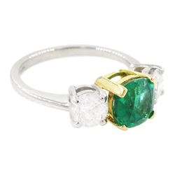 Platinum emerald and diamond three stone ring, single cushion cut emerald of approx  1.85 carat, set with a single round brilliant cut diamond either side, hallmarked, total diamond weight approx 1.20 carat